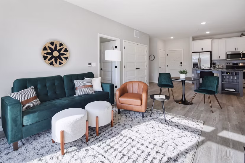 Spacious living room featuring modern decor and large windows at Arasan Apartments