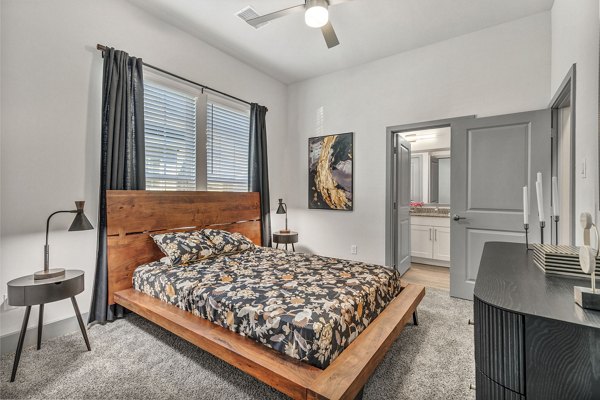 Relaxing bedroom with contemporary decor at Preserve at Highway 6 Apartments, perfect for comfortable living and a tranquil escape