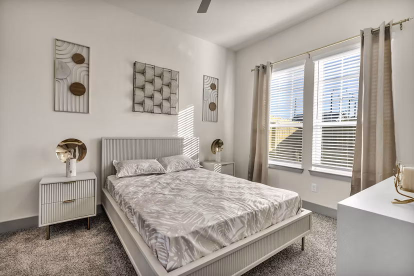 Contemporary bedroom with elegant decor at Preserve at Highway 6 Apartments