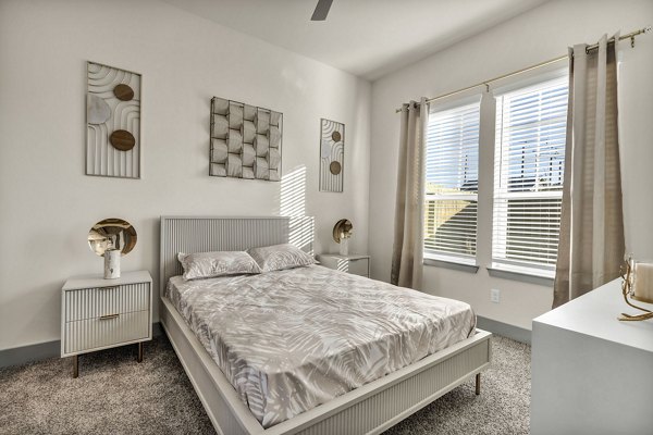 Contemporary bedroom with elegant decor at Preserve at Highway 6 Apartments
