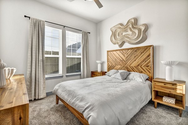 Cozy bedroom with modern decor at Preserve at Highway 6 Apartments, featuring stylish furniture and soft lighting