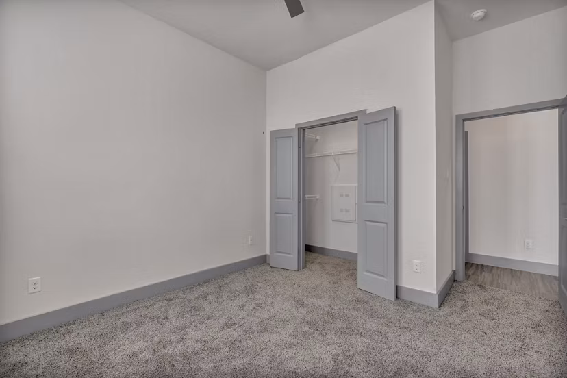 Cozy bedroom with large windows at Preserve at Highway 6 Apartments offering natural light and stylish decor