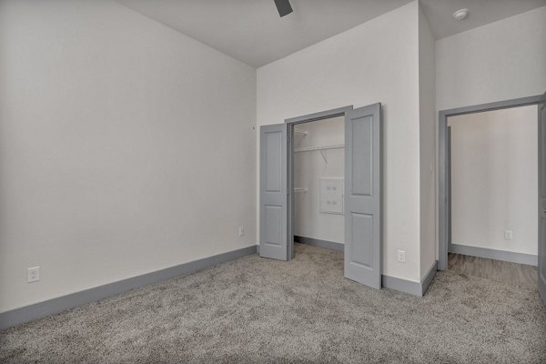 Cozy bedroom with large windows at Preserve at Highway 6 Apartments offering natural light and stylish decor