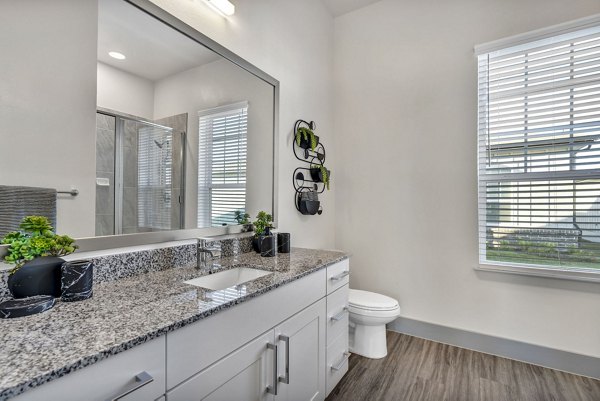 Modern bathroom with sleek fixtures at Preserve at Highway 6 Apartments