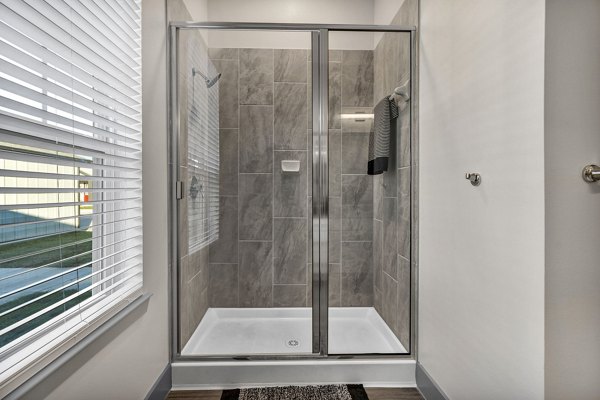 Modern bathroom with elegant fixtures at Preserve at Highway 6 Apartments