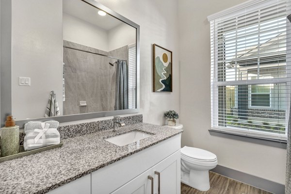 Modern bathroom with sleek fixtures at Preserve at Highway 6 Apartments featuring spa-inspired design