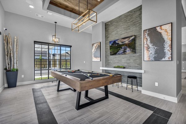 Clubhouse with modern design and ample seating at Preserve at Highway 6 Apartments, offering residents a stylish and comfortable gathering space
