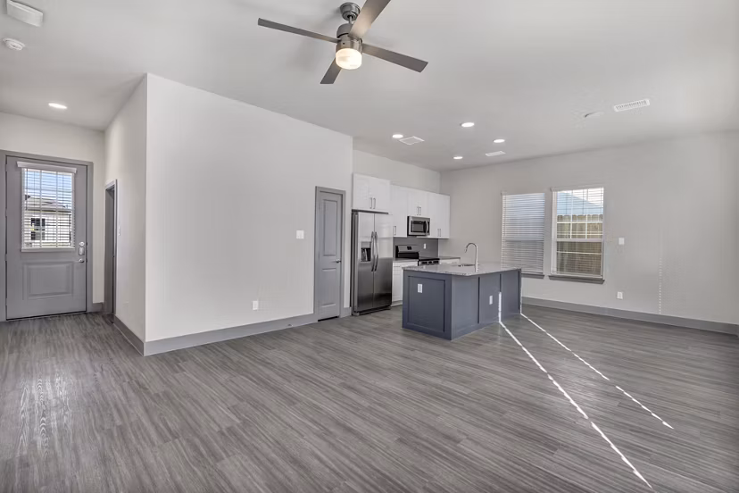 Modern kitchen with stainless steel appliances in Preserve at Highway 6 Apartments
