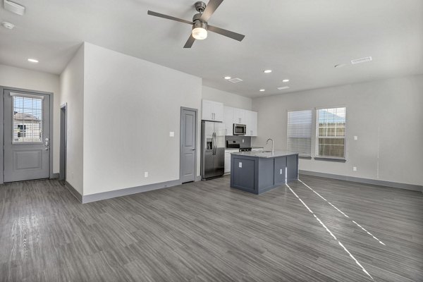 Modern kitchen with stainless steel appliances in Preserve at Highway 6 Apartments