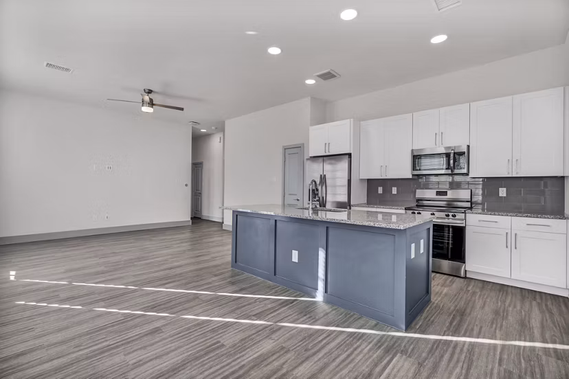Spacious kitchen with granite countertops at Preserve at Highway 6 Apartments