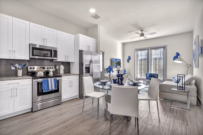 Modern kitchen with granite countertops and stainless steel appliances at Preserve at Highway 6 Apartments