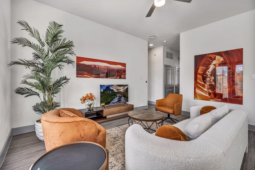 Elegant living room with modern furniture at Preserve at Highway 6 Apartments, featuring stylish decor and ample natural light