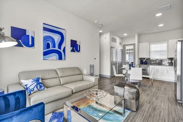 Living room with modern decor and abundant natural light at Preserve at Highway 6 Apartments
