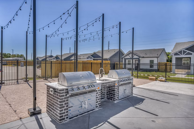 Outdoor grill area with modern seating at Preserve at Highway 6 Apartments