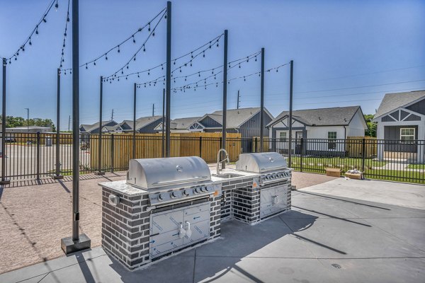 Outdoor grill area with modern seating at Preserve at Highway 6 Apartments