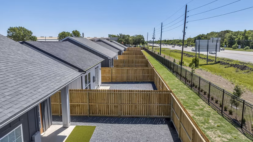 Exterior view of Preserve at Highway 6: Luxury apartment community with lush landscaping in Houston