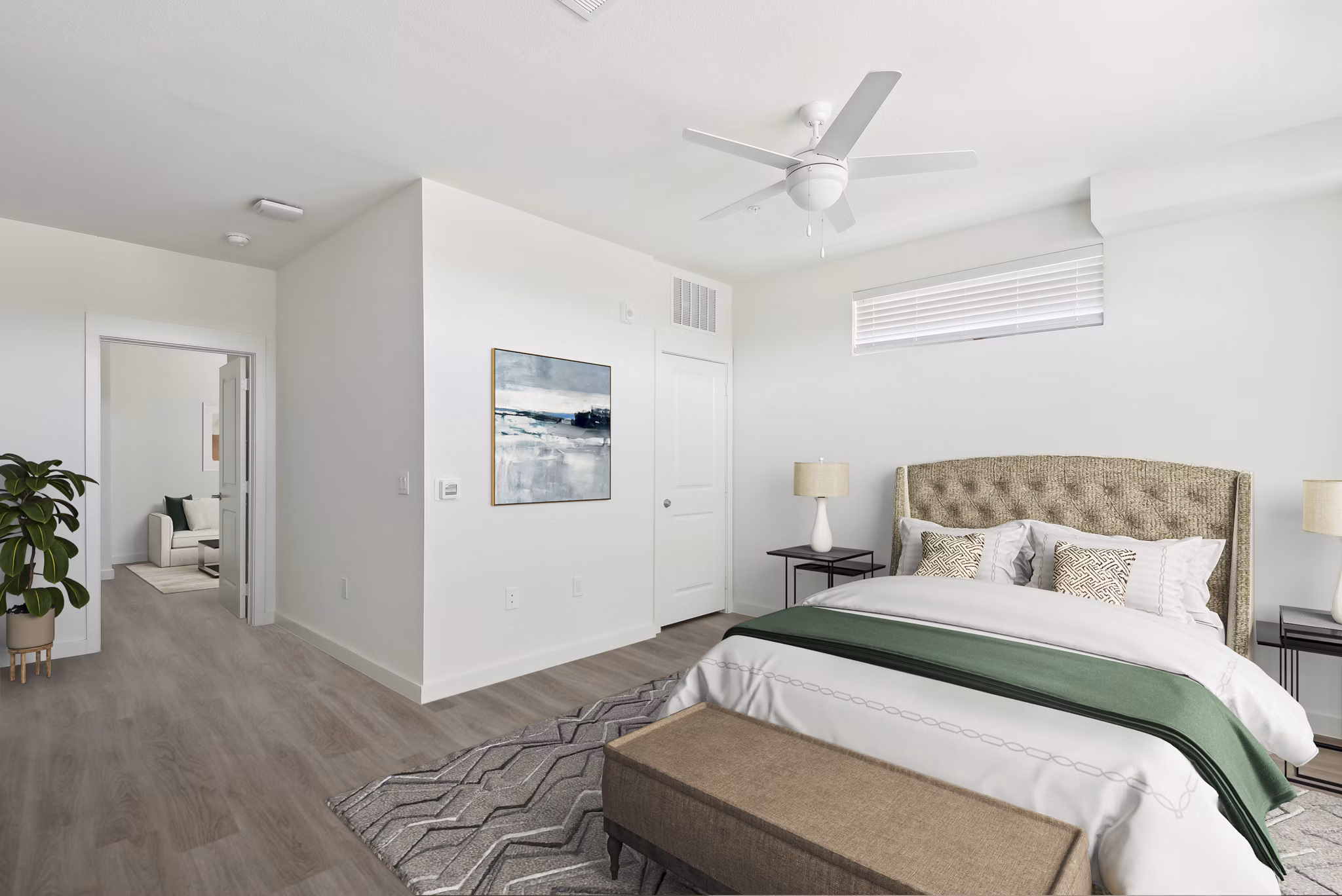 Dreamy bedroom with plush bedding and large window at Bell's Lake Apartments, offering relaxing luxury living in a scenic setting