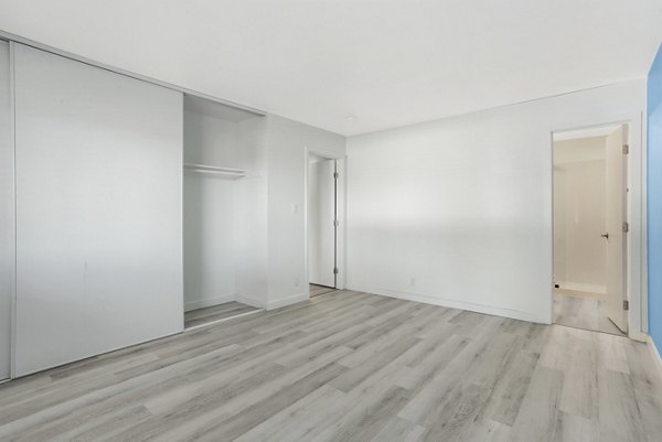 Modern bedroom with cozy decor and city views at Fremont City Center Apartments