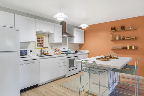 Modern kitchen with stainless steel appliances and granite countertops at Fremont City Center Apartments