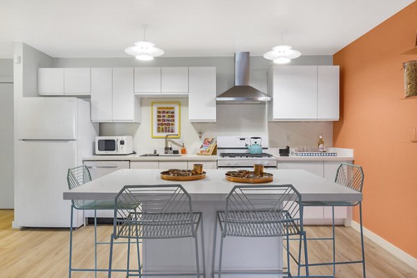 Open-concept kitchen featuring modern appliances at Fremont City Center Apartments