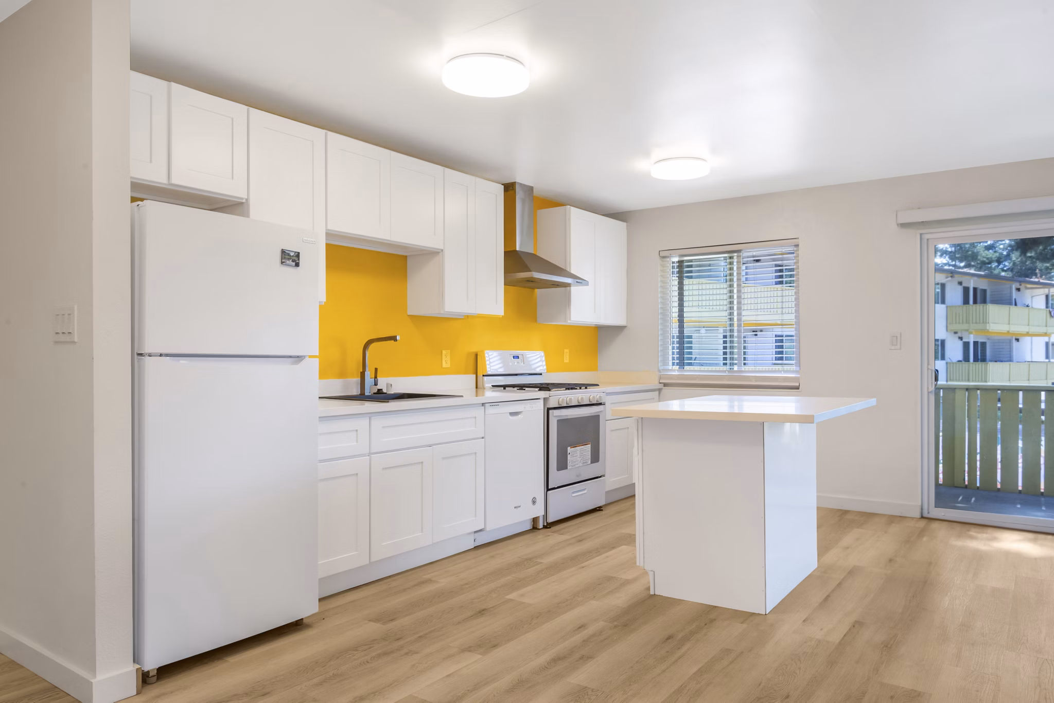 Modern kitchen with stainless steel appliances at Fremont City Center Apartments, featuring sleek countertops and ample natural lighting
