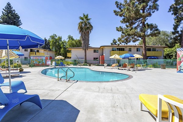 Outdoor pool surrounded by modern seating at Fremont City Center Apartments