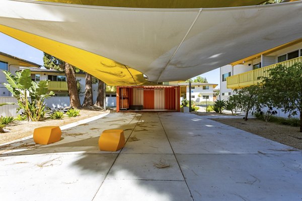 Spacious patio with seating and greenery at Fremont City Center Apartments, offering a serene outdoor retreat for relaxation