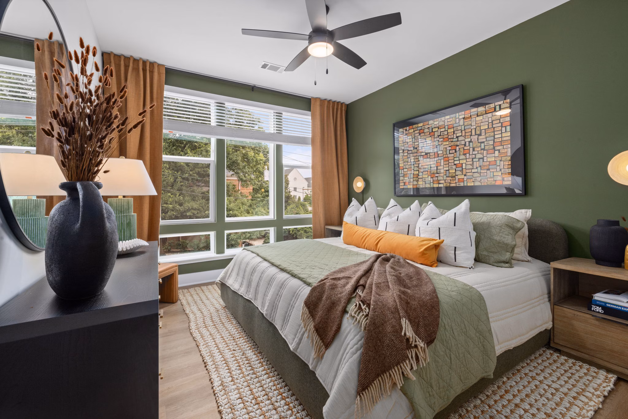 Cozy bedroom with contemporary design at The Point Apartments, featuring modern furnishings and ample natural light for luxury living