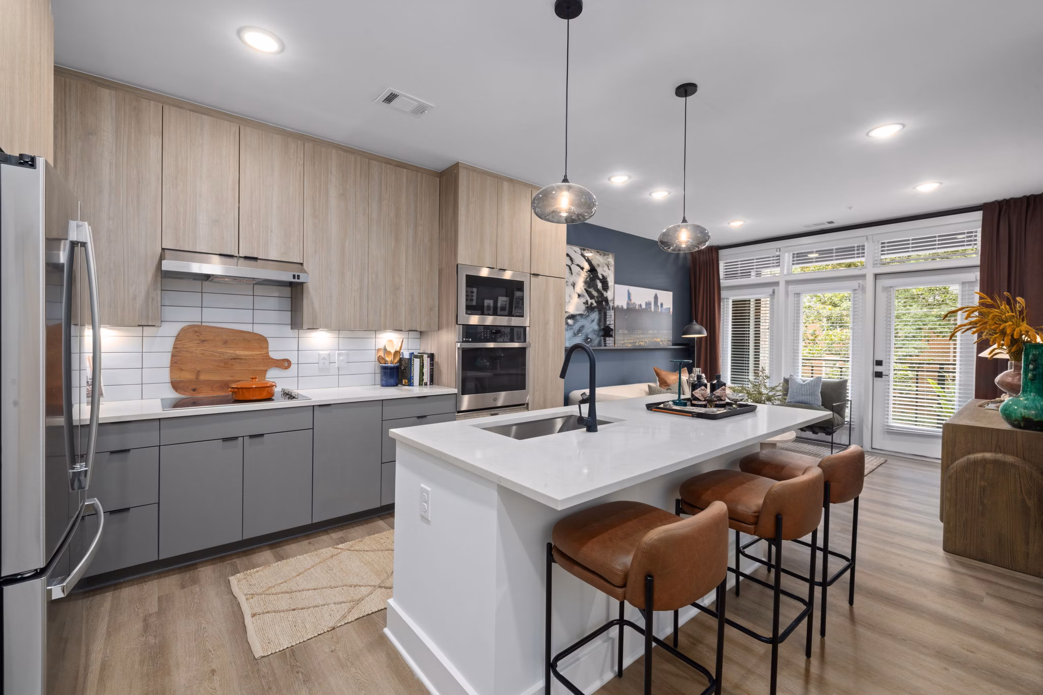 Modern kitchen featuring a spacious island and stainless steel appliances at The Point Apartments