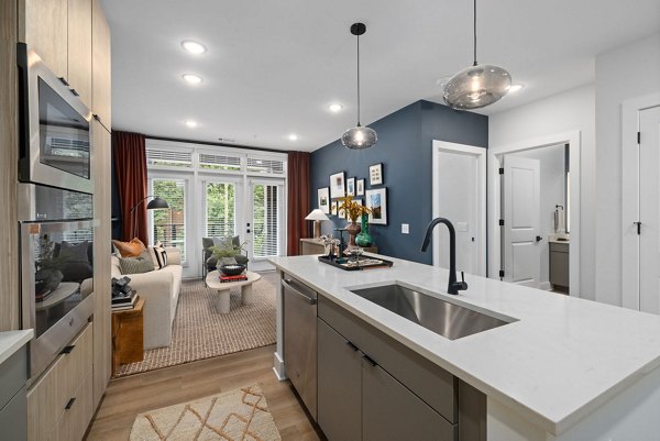 Modern kitchen with stainless steel appliances and sleek countertops at The Point Apartments