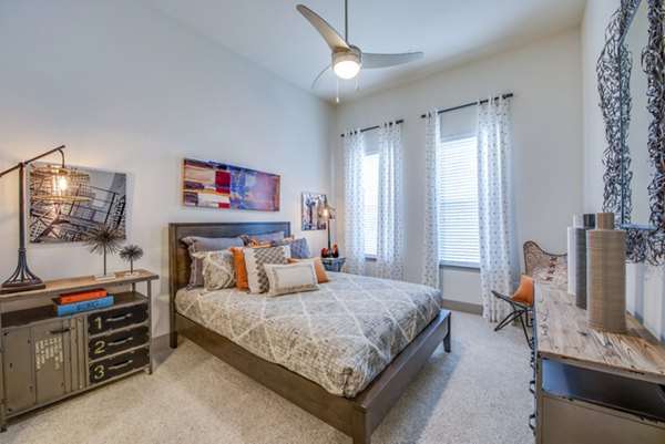 Elegant bedroom with plush bedding and modern decor at Bellrock Upper North Apartments