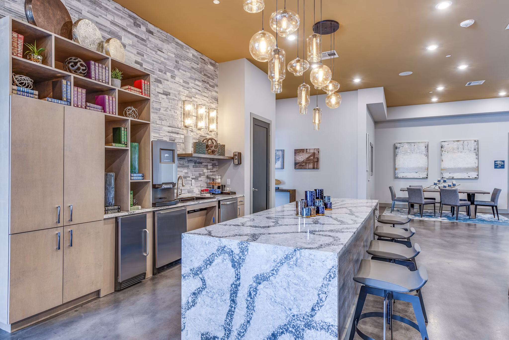 Modern clubhouse with cozy seating and pool table at Bellrock Upper North Apartments in Gainesville