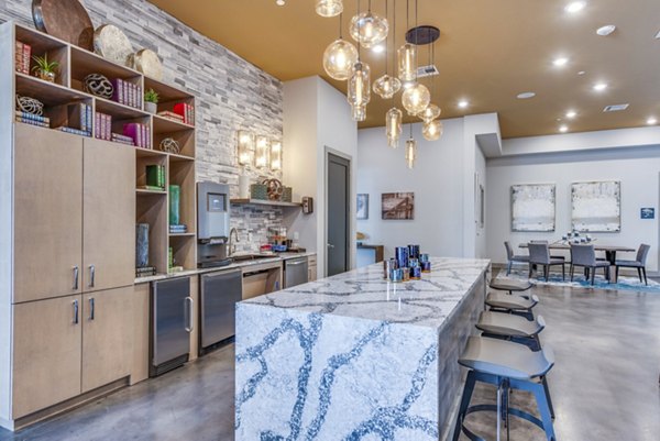 Modern clubhouse with cozy seating and pool table at Bellrock Upper North Apartments in Gainesville