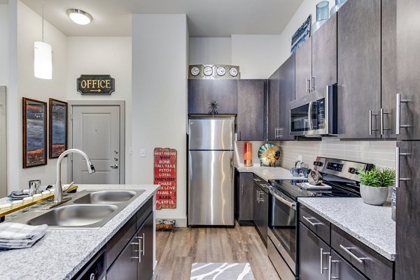 Modern kitchen with stainless steel appliances at Bellrock Upper North Apartments