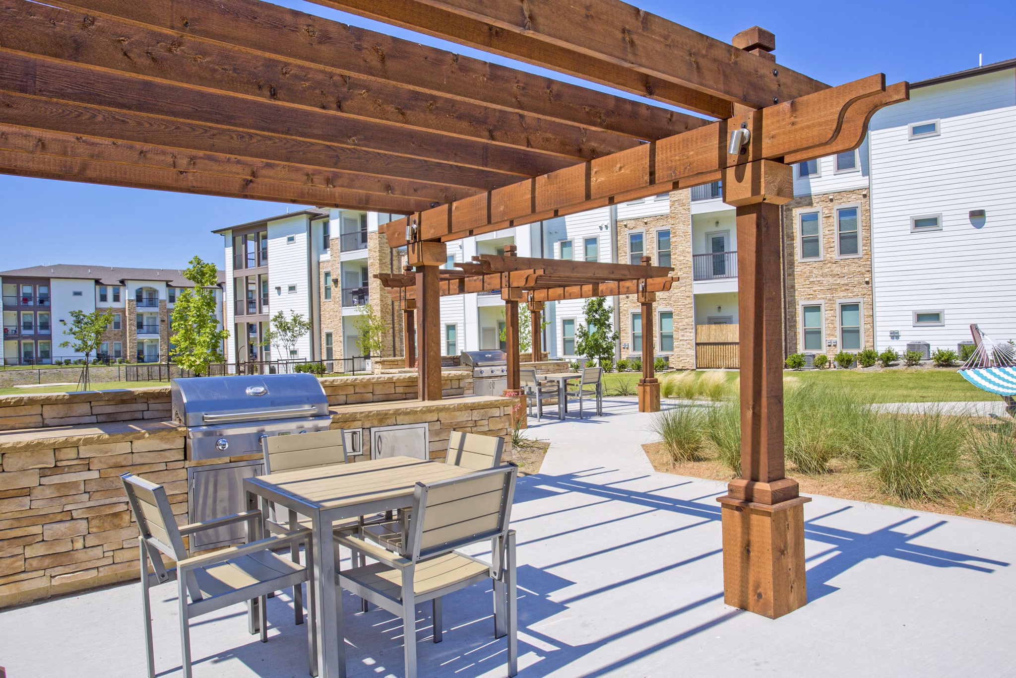 Modern grill area and patio at Bellrock Upper North Apartments, perfect for outdoor dining and socializing