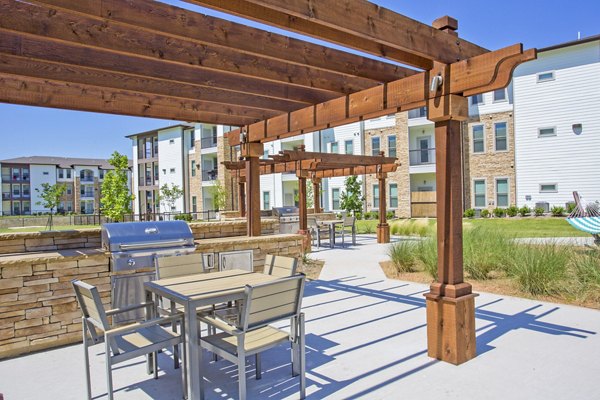 Modern grill area and patio at Bellrock Upper North Apartments, perfect for outdoor dining and socializing