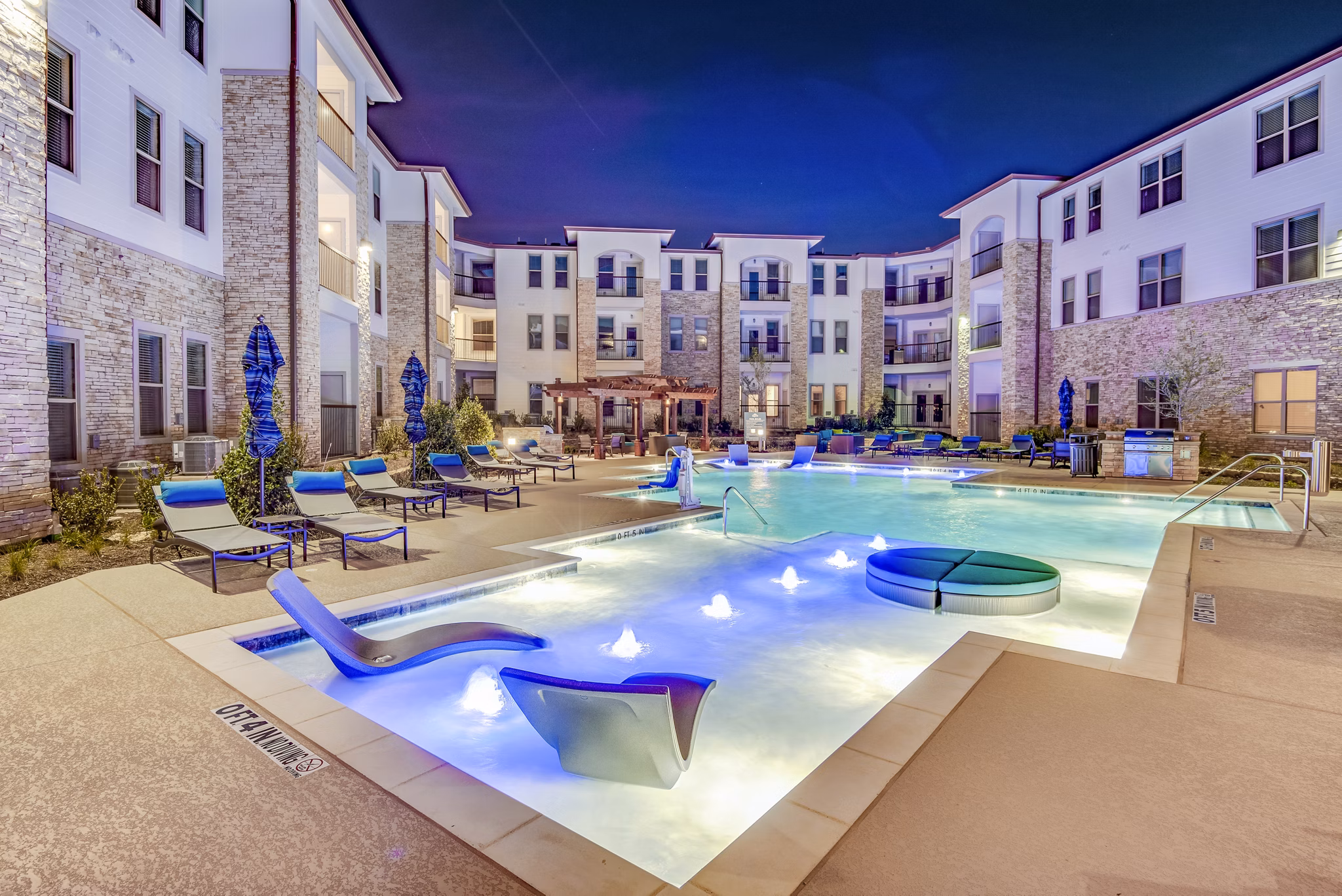 Resort-style pool with lounge chairs at Bellrock Upper North Apartments, luxury living in a serene environment