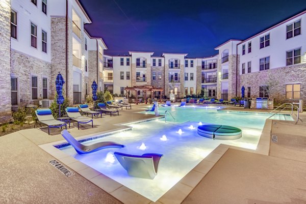 Resort-style pool with lounge chairs at Bellrock Upper North Apartments, luxury living in a serene environment