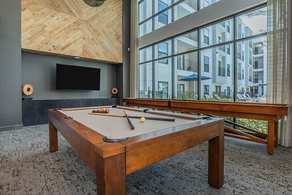 Modern clubhouse with entertainment lounge and workspace at Vibe Med Center Apartments in Houston