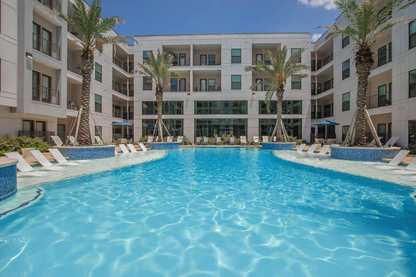 Modern pool area with lounge chairs at Vibe Med Center luxury apartments, ideal for relaxation and socializing