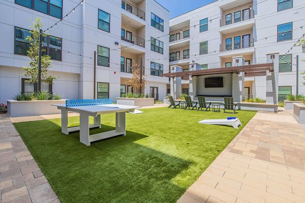 Courtyard featuring lush gardens and seating at Vibe Med Center Apartments, a Greystar luxury apartment community in Houston