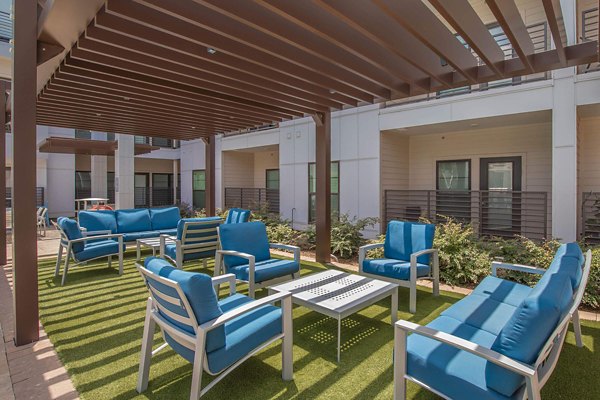 Modern patio with cozy seating at Vibe Med Center Apartments, offering luxury living and outdoor relaxation in a prime Houston location