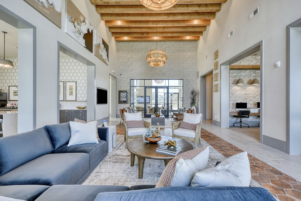 Living room with modern decor and large windows at The Overlook at The Rim Apartments, offering a luxurious living experience