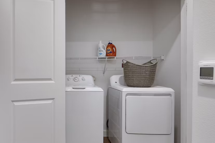 Laundry facility with modern machines at The Overlook at The Rim Apartments, offering convenient amenities for residents