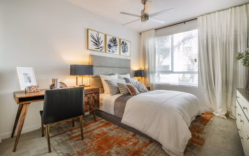 Cozy bedroom with modern decor at MODA at Monrovia Station Apartments featuring elegant design and comfortable furnishings