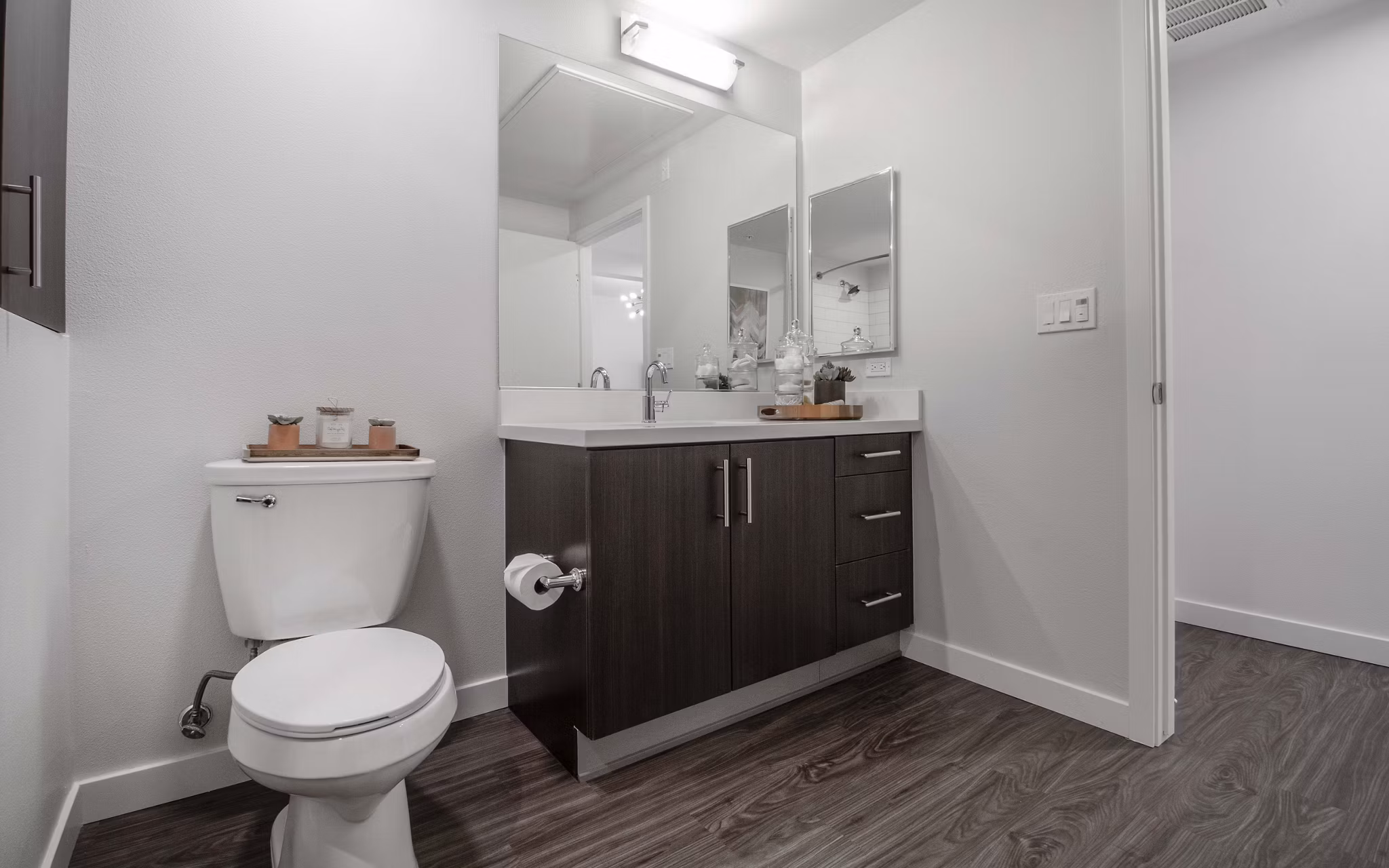 Modern bathroom showcasing sleek fixtures and ample lighting at MODA at Monrovia Station Apartments