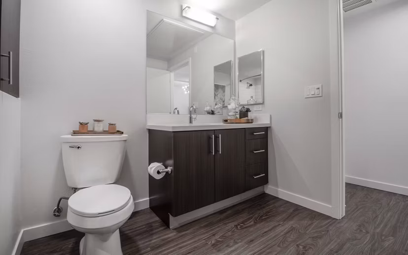 Modern bathroom showcasing sleek fixtures and ample lighting at MODA at Monrovia Station Apartments