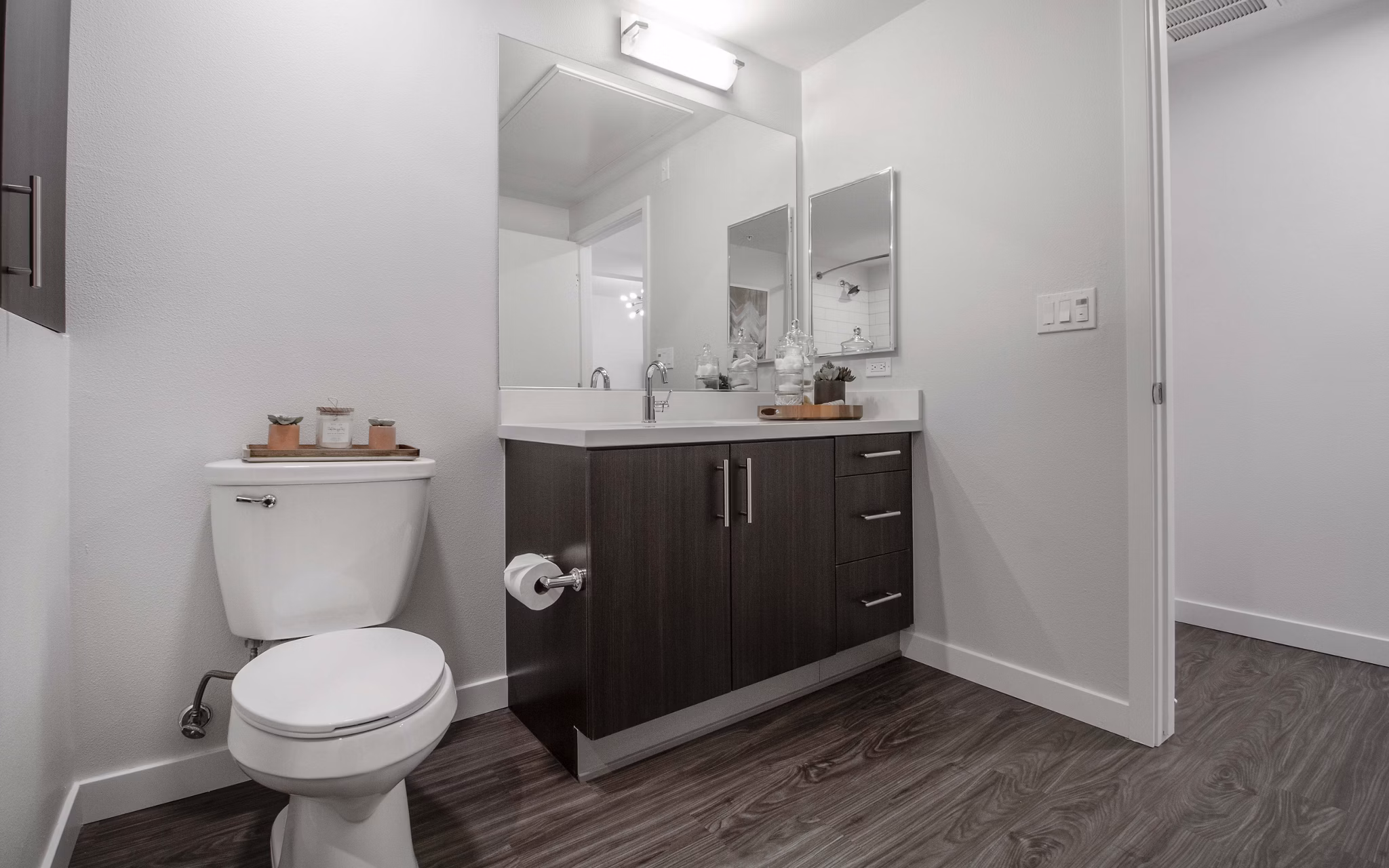 Modern bathroom showcasing sleek fixtures and ample lighting at MODA at Monrovia Station Apartments