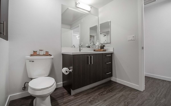 Modern bathroom showcasing sleek fixtures and ample lighting at MODA at Monrovia Station Apartments