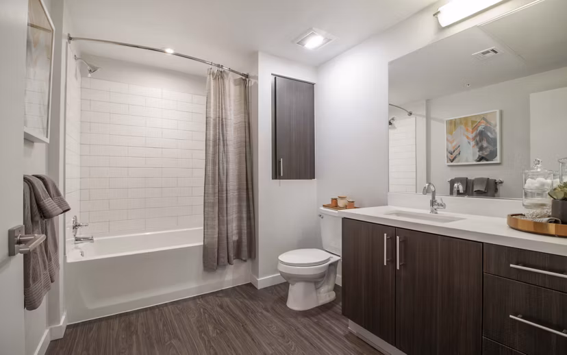 Modern bathroom with glass shower and sleek fixtures in MODA at Monrovia Station Apartments